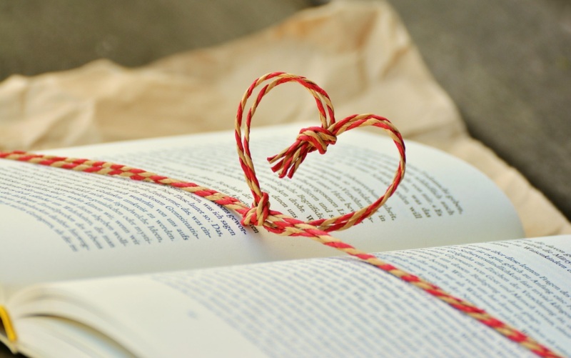 Open book with string heart